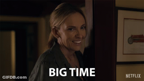 A Woman Says Big Time In Front Of A Picture Of A Motorcycle GIF