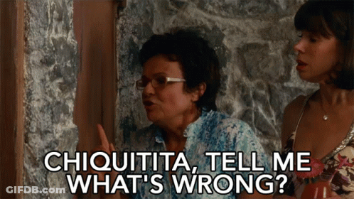 A Woman Says " Chiquita Tell Me What 'S Wrong " While Standing Next To Another Woman GIF