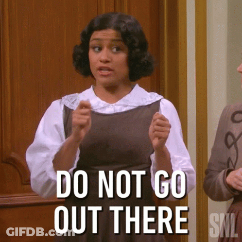 A Woman Says " Do Not Go Out There " While Standing In Front Of A Door GIF