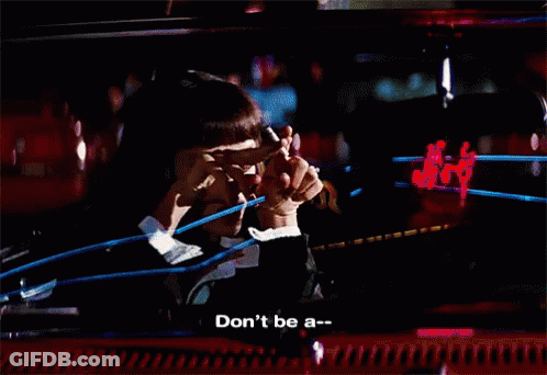 A Woman Says " Don 'T Be A " In Front Of A Blurry Background GIF
