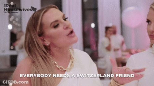 A Woman Says Everybody Needs A Switzerland Friend In Front Of A Pink Background GIF