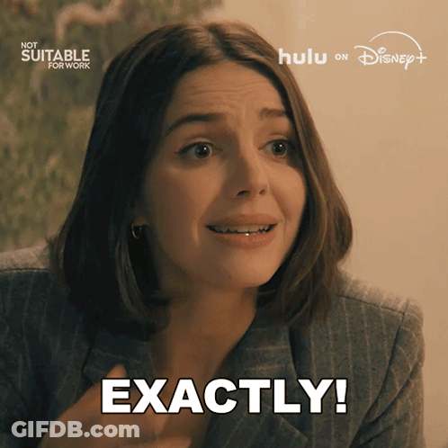 A Woman Says Exactly In Front Of A Sign That Says Now Suitable For Work GIF