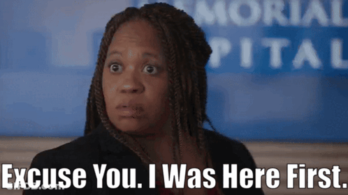 A Woman Says Excuse You I Was Here First In Front Of A Hospital Sign GIF