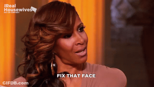 A Woman Says Fix That Face In Front Of A Real Housewives Sign GIF
