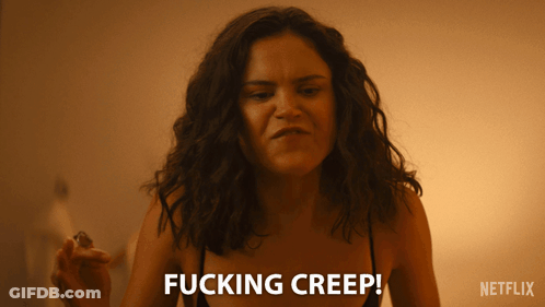 A Woman Says Fucking Creep While Holding A Small Object GIF
