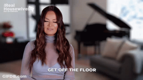 A Woman Says Get Off The Floor While Sitting In A Living Room GIF