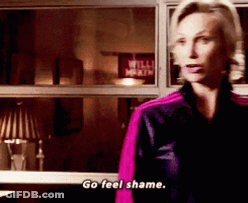 A Woman Says Go Feel Shame While Standing In Front Of A Window GIF