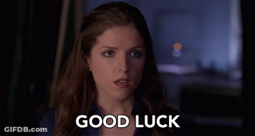 A Woman Says " Good Luck " In Front Of A Dark Background GIF