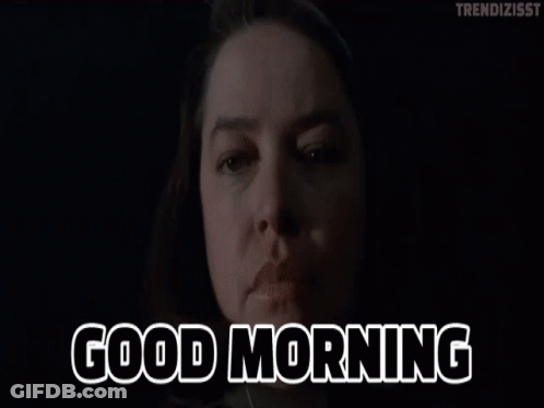 A Woman Says Good Morning In Front Of A Dark Background GIF