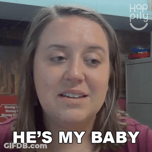 A Woman Says He 'S My Baby In Front Of A Sign GIF