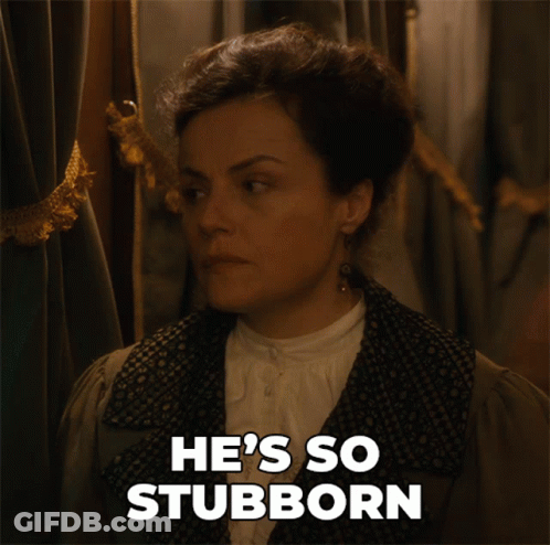A Woman Says He 'S So Stubborn While Standing In Front Of A Curtain GIF