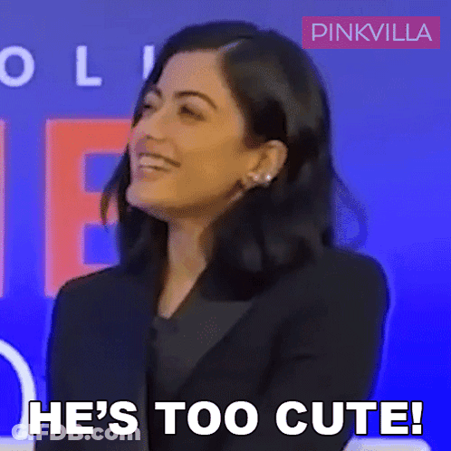A Woman Says He 'S Too Cute In Front Of A Blue Background GIF