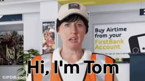 A Woman Says Hi I 'M Tom In Front Of A Sign That Says Buy Airtime From Your First Bank Account GIF