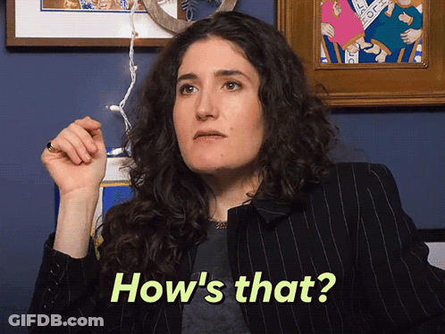A Woman Says How 'S That While Holding A Pen GIF