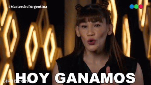 A Woman Says " Hoy Ganamos " In Front Of A Wall Of Lights GIF