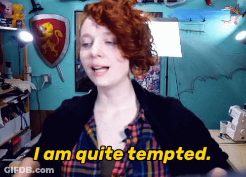 A Woman Says " I Am Quite Tempted " In Front Of A Blue Wall GIF