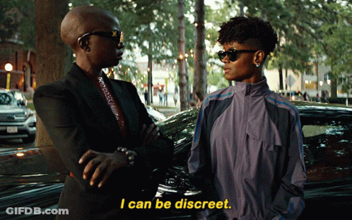 A Woman Says I Can Be Discreet While Standing Next To Another Woman In Front Of A Car GIF