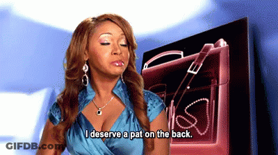 A Woman Says I Deserve A Pat On The Back In Front Of A Pink Purse GIF