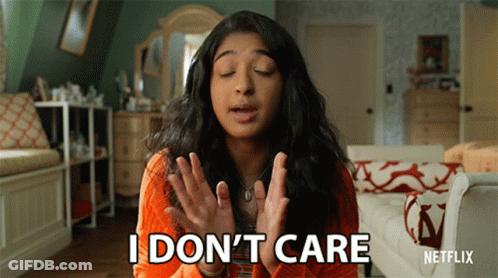 A Woman Says I Don 'T Care In Front Of A Couch GIF