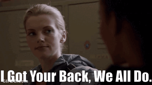 A Woman Says " I Got Your Back We All Do " In Front Of A Locker GIF