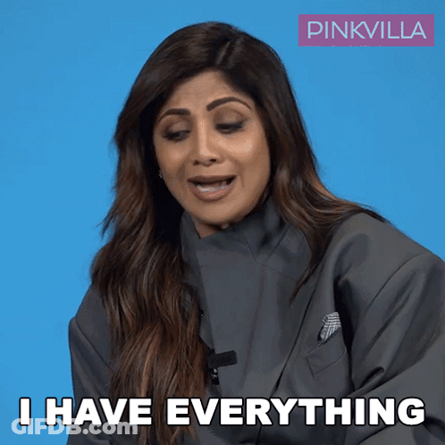 A Woman Says I Have Everything In Front Of A Blue Background GIF