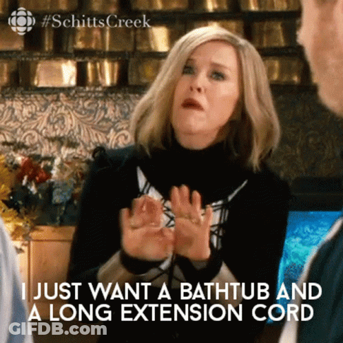 A Woman Says " I Just Want A Bathtub And A Long Extension Cord " In A Scene From Schitts Creek GIF
