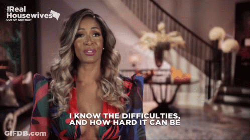 A Woman Says " I Know The Difficulties And How Hard It Can Be " In Front Of A Sign That Says Real Housewives GIF