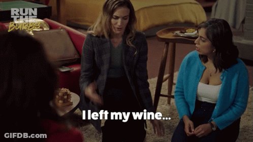 A Woman Says " I Left My Wine " While Sitting In A Living Room GIF