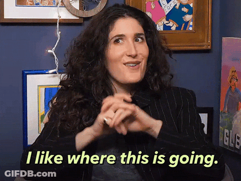 A Woman Says " I Like Where This Is Going " In Front Of Framed Pictures GIF