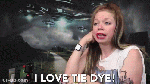 A Woman Says I Love Tie Dye In Front Of A Picture Of Aliens GIF