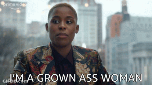 A Woman Says " I 'M A Grown Ass Woman " In Front Of A City Skyline GIF