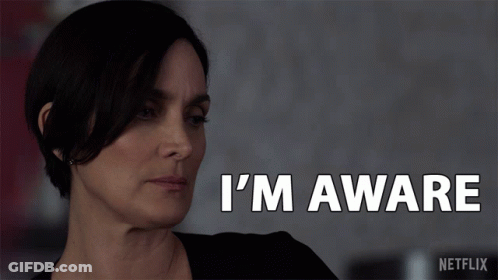 A Woman Says I 'M Aware In White Letters GIF