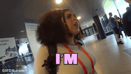 A Woman Says I 'M In Pink Letters On Her Shirt GIF