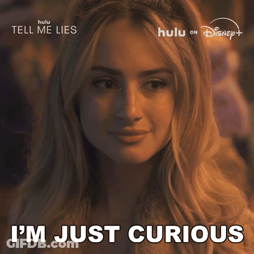 A Woman Says " I 'M Just Curious " In Front Of A Disney Poster GIF