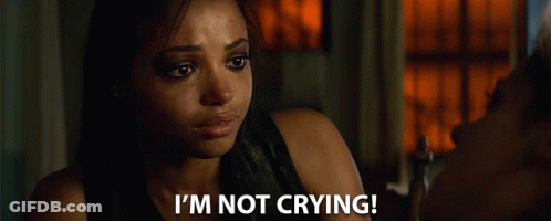 A Woman Says " I 'M Not Crying " In Front Of A Window GIF