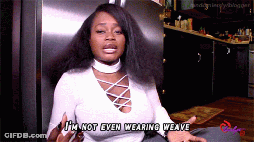 A Woman Says I 'M Not Even Wearing Weave In Front Of A Refrigerator GIF
