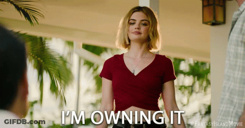 A Woman Says I 'M Owning It In A Red Shirt GIF