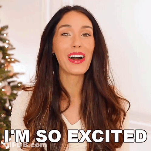 A Woman Says I 'M So Excited Next To A Christmas Tree GIF