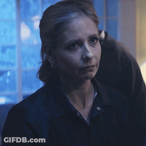 A Woman Says I 'M Sorry In Front Of A Blue Background GIF