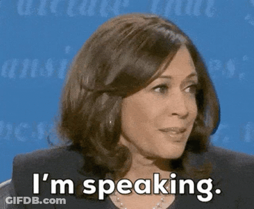 A Woman Says I 'M Speaking In Front Of A Blue Wall GIF