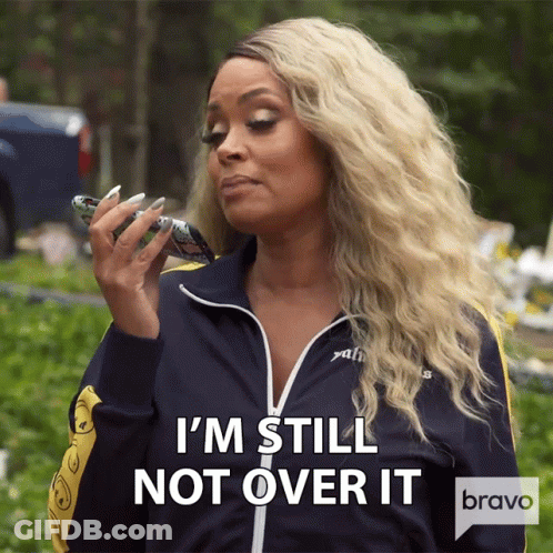 A Woman Says I 'M Still Not Over It While Holding A Cellphone GIF