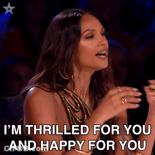 A Woman Says " I 'M Thrilled For You And Happy For You " In Front Of A Microphone GIF