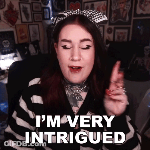 A Woman Says " I 'M Very Intrigued " In A Striped Sweater GIF