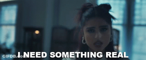 A Woman Says I Need Something Real In A Dark Room GIF