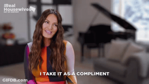 A Woman Says " I Take It As A Compliment " While Sitting In Front Of A Piano GIF