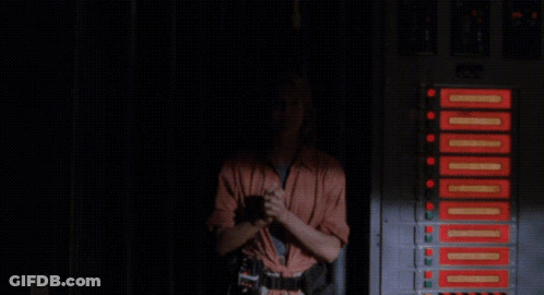 A Woman Says " I Think We 'Re Back In Business " In A Dark Room GIF