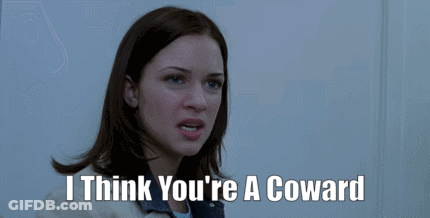 A Woman Says " I Think You 'Re A Coward " In Front Of A Door GIF