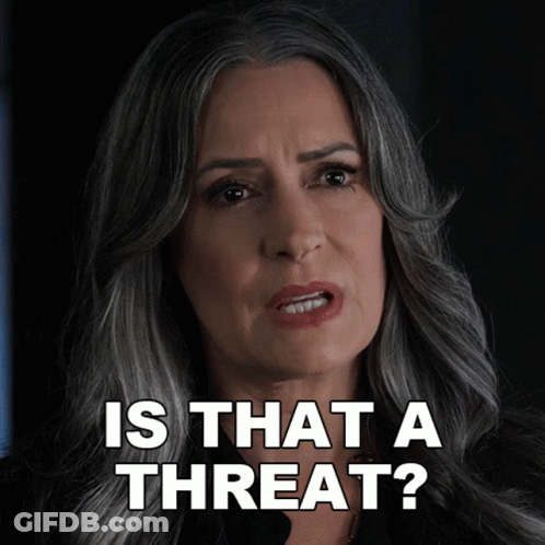 A Woman Says Is That A Threat With A Serious Look On Her Face GIF