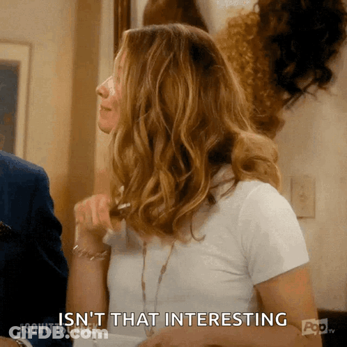 A Woman Says " Isn 'T That Interesting " While Looking At Something GIF