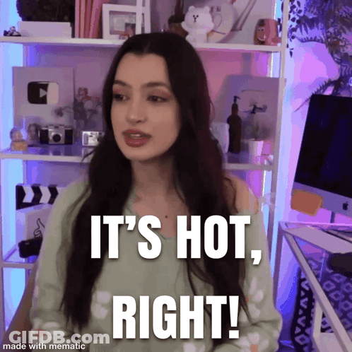 A Woman Says " It 'S Hot Right " While Standing In Front Of A Computer GIF